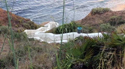 Path leading down to a small, secluded bay Stock Footage 65336392