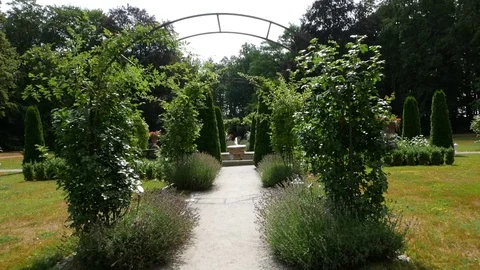 Path leading through the garden arcade. Stockbeeldmateriaal 92833634
