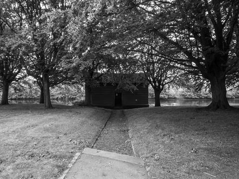 A path leading to a weir control building in a park. Stock Photos