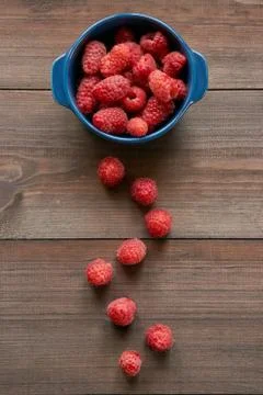 Path made from raspberries to small ceramic bowl full of red raspberries Stock Photos