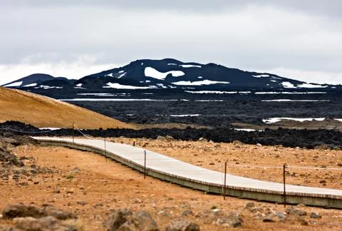 A path made of wood leading through the lava landscape of the Leirhnjukur lav Stock Photos