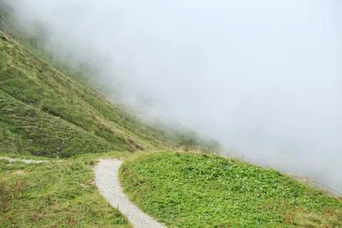 Path in mountains into fog Stock Photos