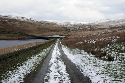Path into the mountains with melting snow Stock Photos