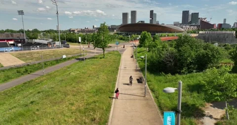 Path in Olympic park and Lee Valley Velopark in background Stock Footage 201470469