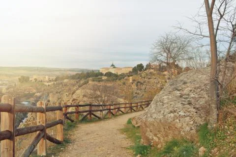 A path over the hill with a view to surroundings of Toledo, wooden rural fenc Stock Photos