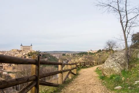 A path over the hill vith a view to Toledo Alcazar, evening at surroundings.. Stock Photos