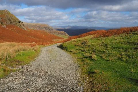 Path over the mountains through heather and bracken, Lake District Stock Photos