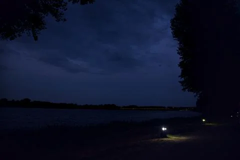 Path in a park by the lakeshore at twilight Stock Photos