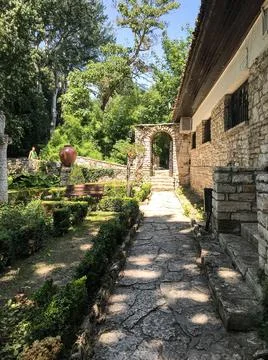 The path in the park is paved with stone. Decorative trail or road in the gar Stock Photos