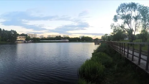 Path by the pond in the evening timelapse Stock Footage 77283096