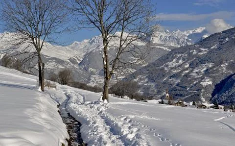 Path  on the snow  with beautiful view on snowcapped mountain and alpine vi.. Stock Photos