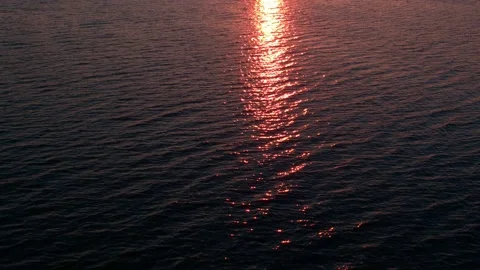 The path of the sunset rays is reflected on the surface of the lake. Ripples on Stock Footage 155000399