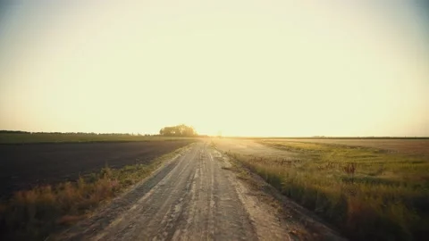 Path to sunset. Rural landscape in the early morning. Dirt road at sunrise. Stock Footage 149241329