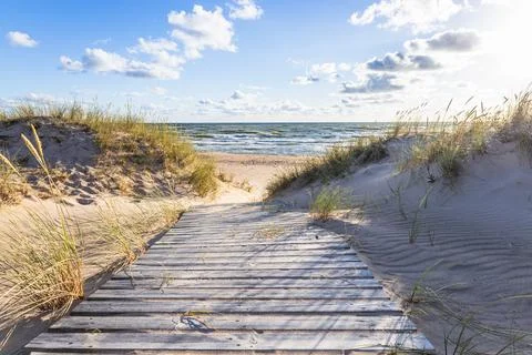 The path through dunes to the sandy beach on the Baltic Sea in summer with a Stock Photos