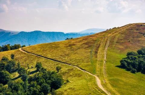 Path through grassy meadows on mountain ridge Stock Photos