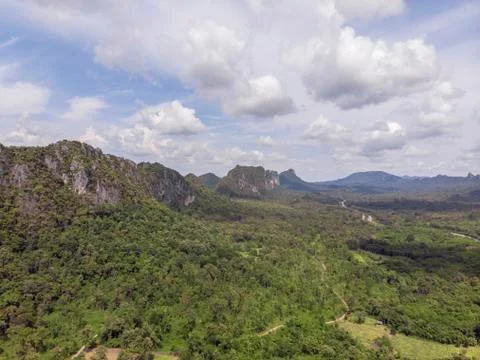 Path through the green forest and countryside of Thailand, Top view aerial ph Stock Photos