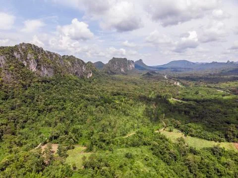 Path through the green forest and countryside of Thailand, Top view aerial ph Stock Photos