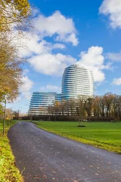 Path through the park in front of the modern tax authorities office in Gron.. Stock Photos
