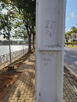 Path through the park with a pole in the middle of the path Stock Photos
