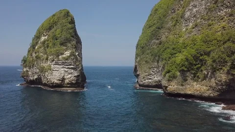 Path towards the ocean thought the green rocks water view aerial footage Stock Footage 101666439