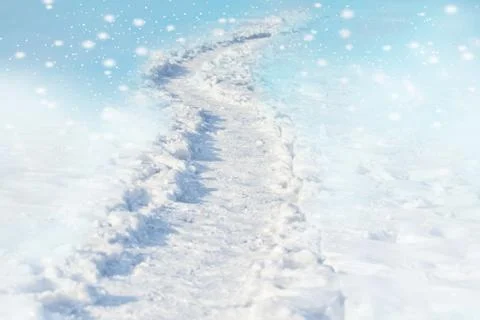 Path trail on winter white snow field on the blue background Stock Photos