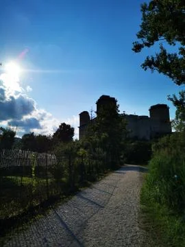 A path with trees on the side of a building Stock Photos