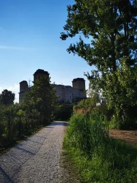 A path with trees on the side of a building Stock Photos