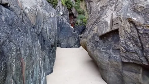 Path in a wild rocky gorge on the sandy beach of the seashore on a summer da Stock Footage 236644413