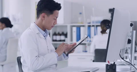 Pathologist, biochemist and genetic engineer using technology to record test Stock Footage 200489387