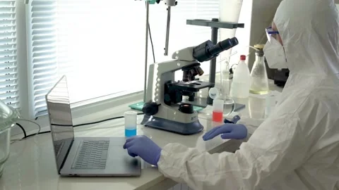 A pathologist examines a human tissue sample under a sophisticated microscope Stock Footage 336582820