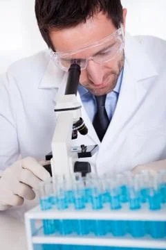 Pathologist or lab technician using a microscope Stock Photos