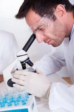 Pathologist or lab technician using a microscope Stock Photos