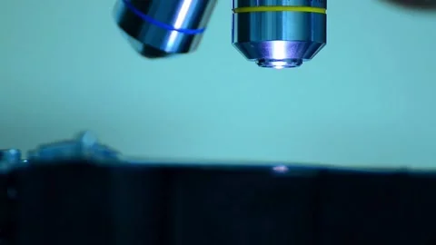 A pathologist is studying diseased tissue under a microscope. 2k 60fps Stock Footage 336583292