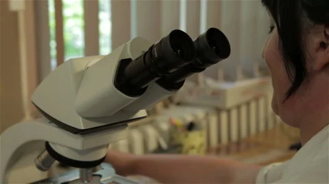 Pathology. Doctor pathologist analyzed tissue sample with microscope, tilt down. Stock Footage 53086132