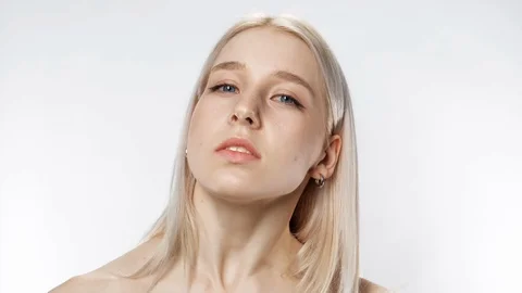 Pathos charming girl looking at camera expressive closeup on white background 4K Stock Footage 120308181