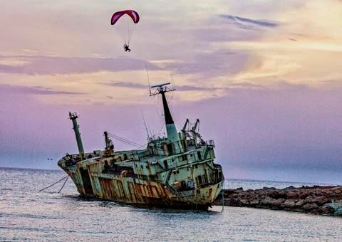Pathos, Cyprus - May 21, 2016 - Person uses powered paraglide to circle a shi Fotos de archivo