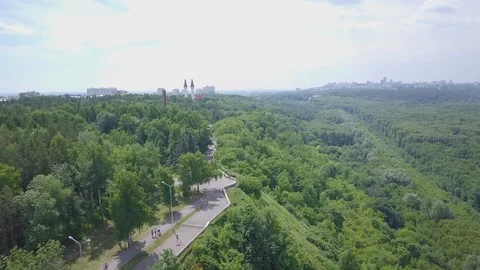 Pathway along the edge of the hill in the dense park Stock Footage 92369274