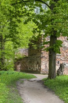 Pathway to Ancient Brick Ruins Surrounded by Lush Spring Foliage Stock Photos