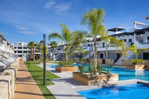 Pathway and landscaped poolside view at Innova Beach Punta Prima modern hol.. Stock Photos