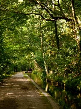 Pathway besides calm canal Stock Photos