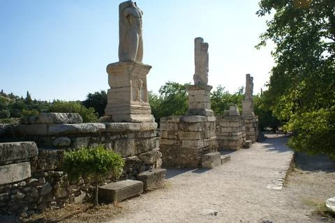 Pathway flanked by statues in the Ancient Agora of Athens, Greece Stock Photos