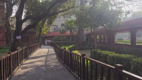 Pathway inside Jallianwala Bagh garden, Amritsar, surrounded by greenery Stock Footage 317332739