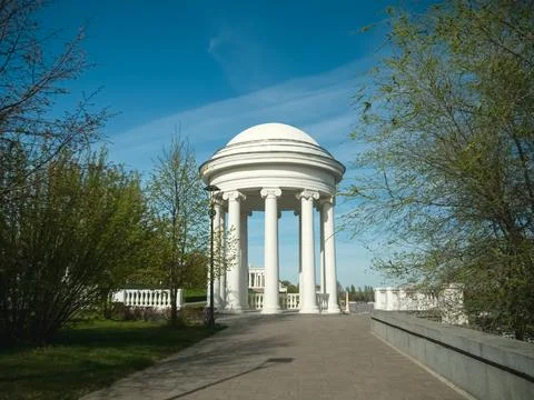 Pathway leading to classical white rotunda in park Stock Photos