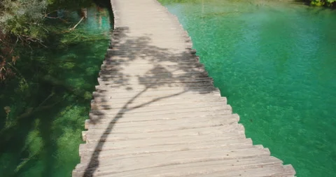 Pathway leading through vibrant greenery by the lakeside Plitvice Lakes National Video stock 310420491