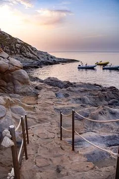 Pathway over granite rocks at sunset at Capo Sant Andrea, Elba Island, Italy 写真素材