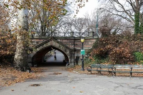 Pathway passing under a stone bridge in Central Park Stock Photos