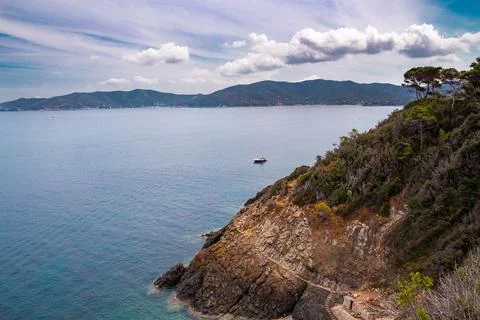Pathway with small steps carved in stone to little Crocetta beach, situated near Stock Photos