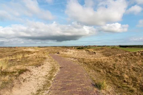 Pathway through the dunes to a small town in the Netherlands Stock Photos