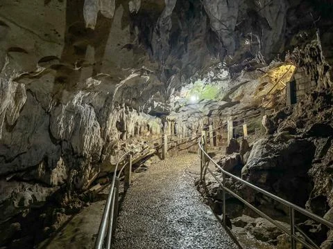 Pathway Through an Illuminated Cave Stock Photos