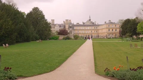 Pathway Through Manicured Gardens Leading to Historic Trinity College Building Stock Footage 339040153